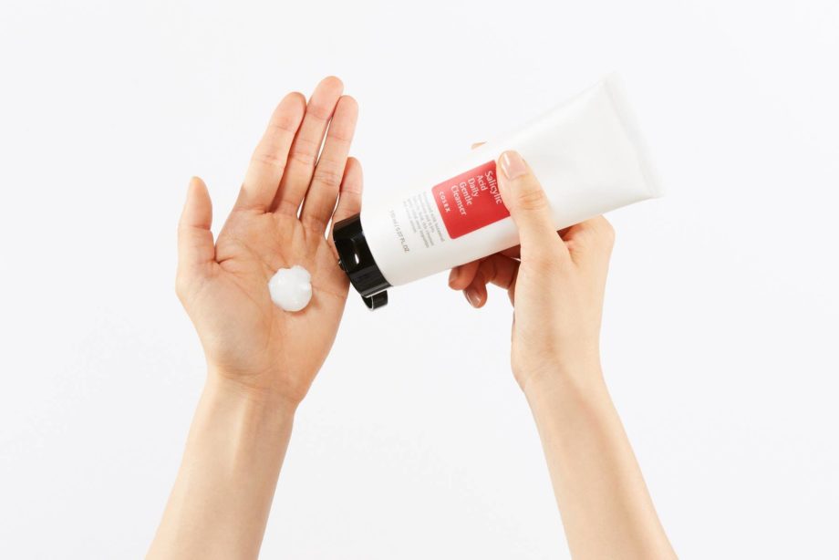 CosRX Salicylic Acid Daily Gentle Cleanser being squeezed into a hand